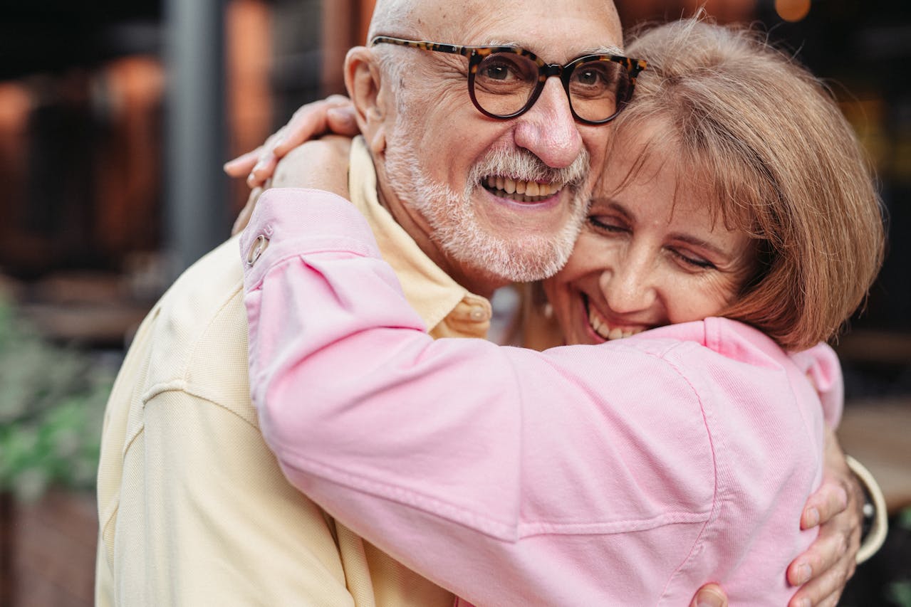 Photo by SHVETS production: https://www.pexels.com/photo/man-in-yellow-shirt-and-eyeglasses-hugging-woman-in-pink-shirt-