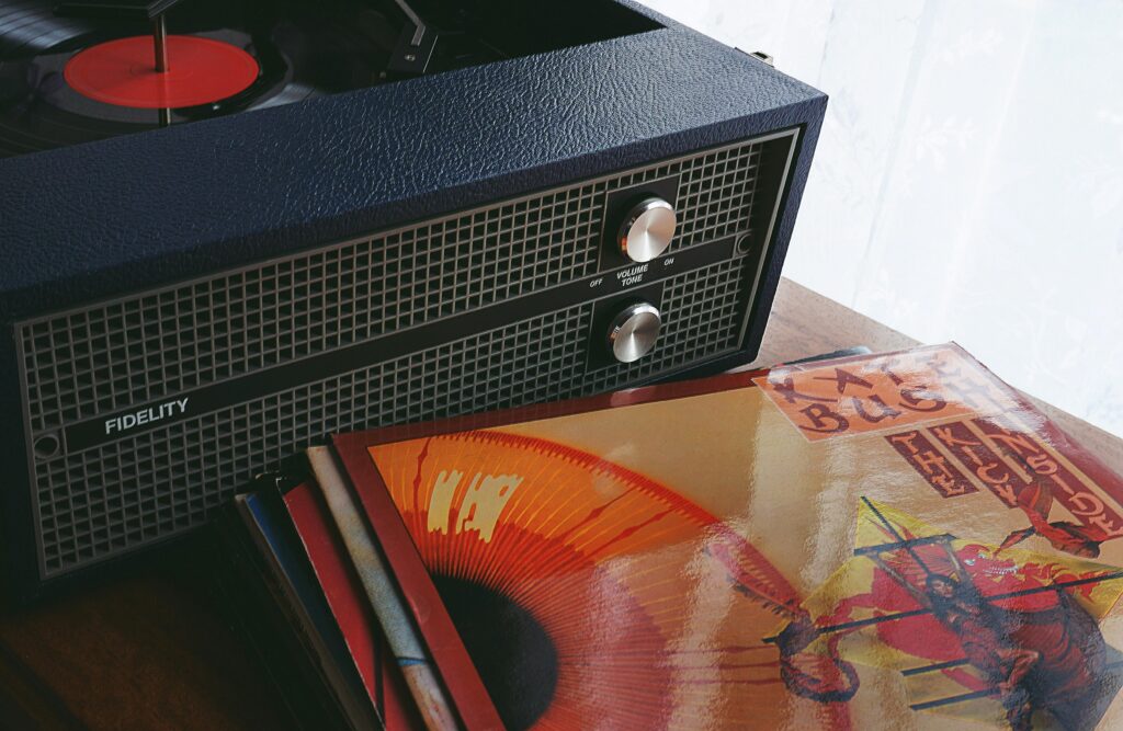 black-speaker-beside-vinyl-sleeve