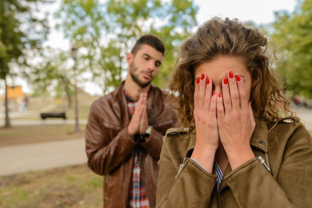 woman-with-green-jacket-behind-man-with-brown-leather-jacket-at-daytime-