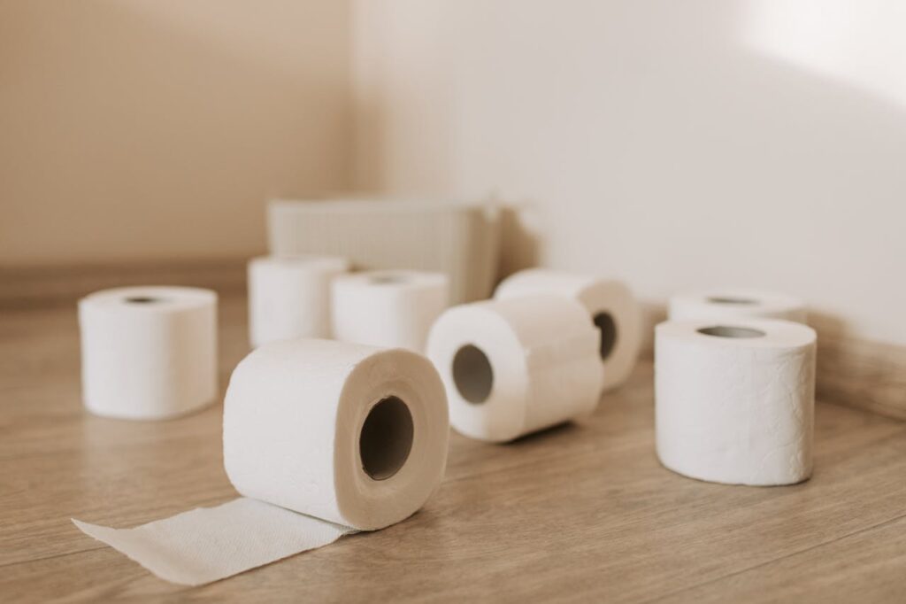 white-toilet-paper-roll-on-wooden-floor-