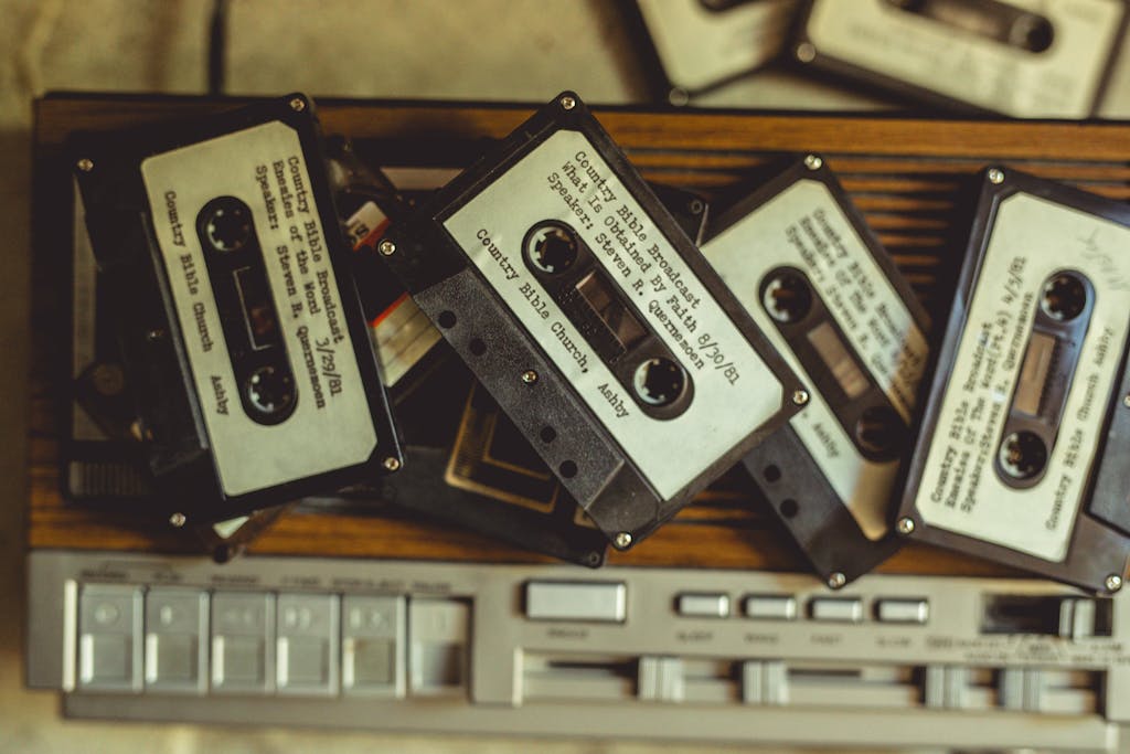 8 Things Baby Boomers Had That the Modern World Destroyed 1 Pile of vintage cassette tapes on a classic audio player, evoking nostalgia and vintage charm.