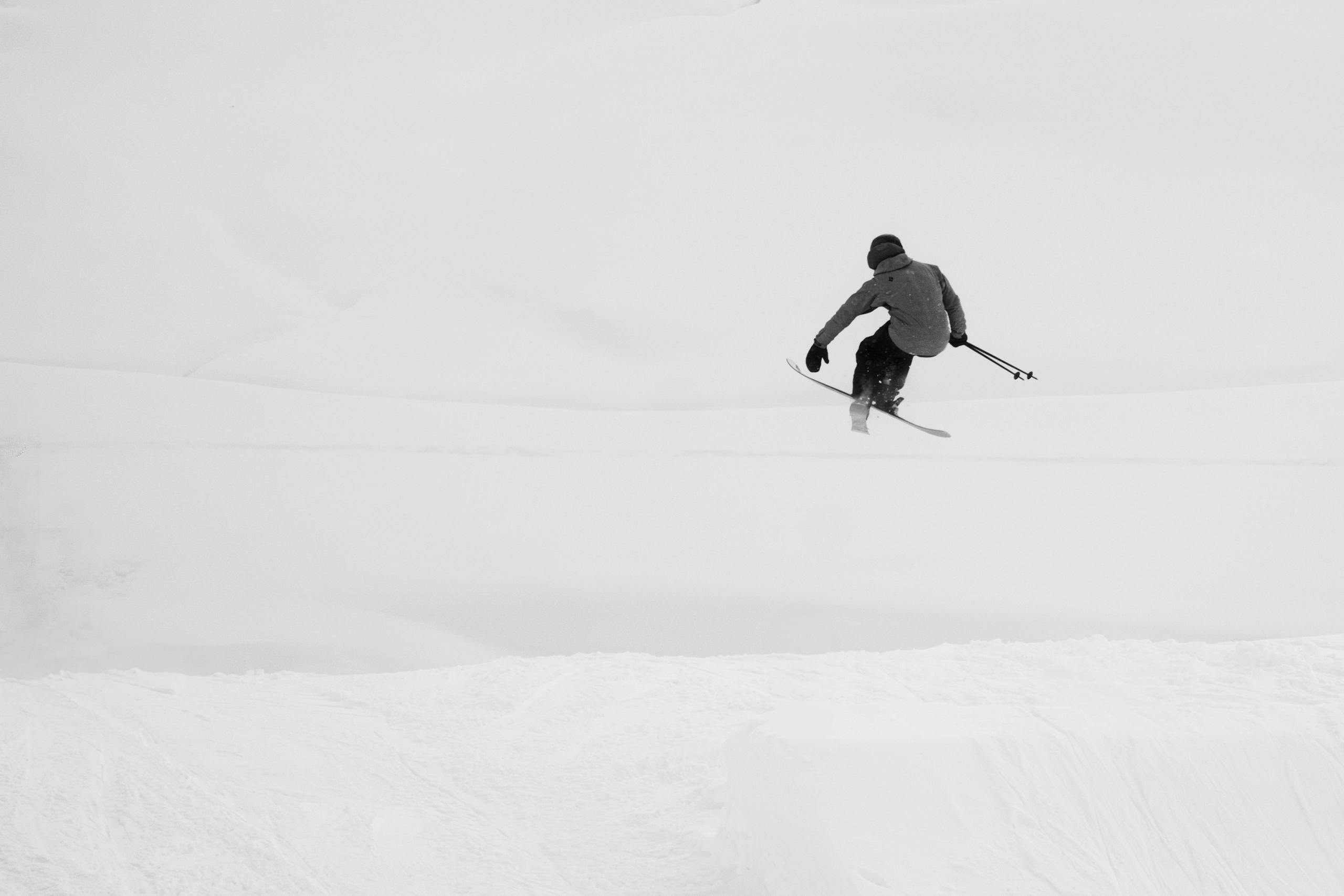 Skier performing freestyle jump in snowy Mayrhofen, Tyrol, Austria.