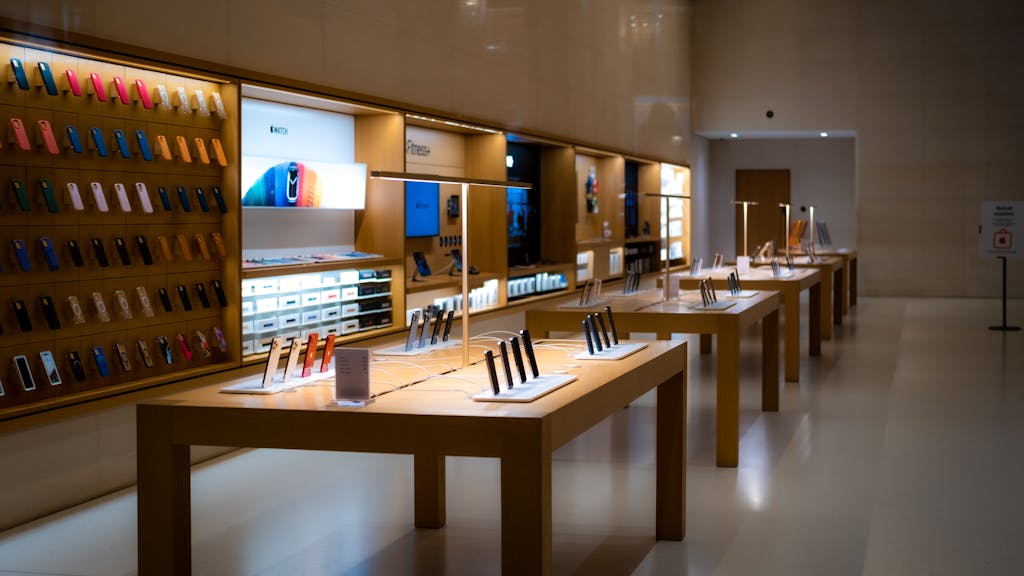 You’re Getting Ripped Off Buying These 8 Things at the Mall 1 Sleek interior of a high-tech store showcasing various mobile devices and accessories.