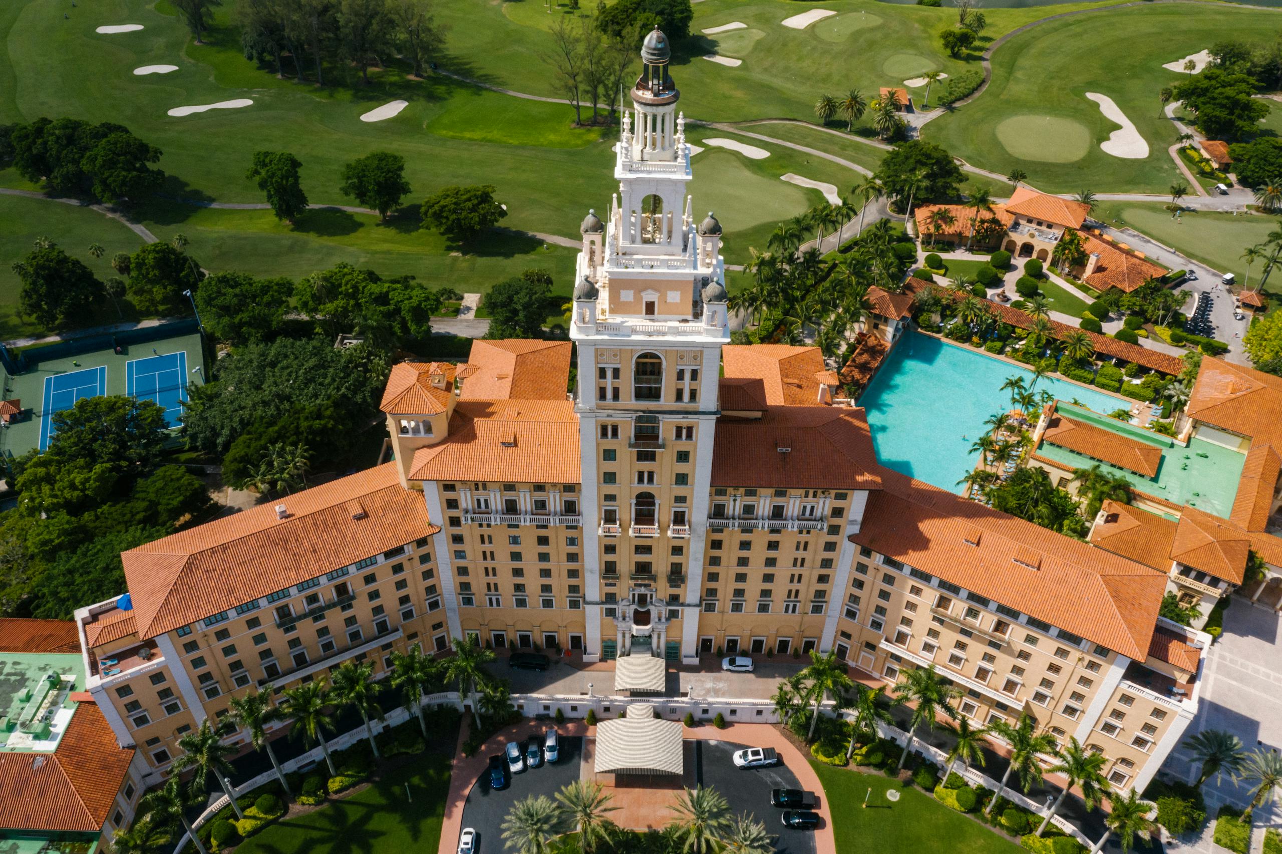 Stunning aerial shot of the historic Biltmore Hotel in Coral Gables, Florida, surrounded by lush greenery.