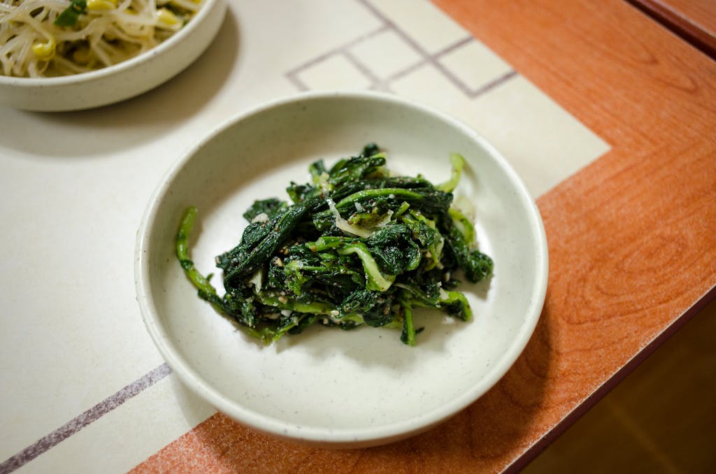 Tasty Asian spinach dish served in a white bowl, ideal for healthy dining.