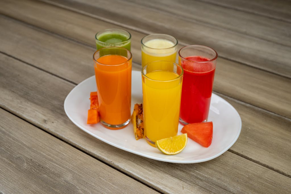 These 10 Morning Foods Are Silently Destroying Your Body 2 Vibrant assorted fruit juices served on a plate with fresh fruits in Salamanca.