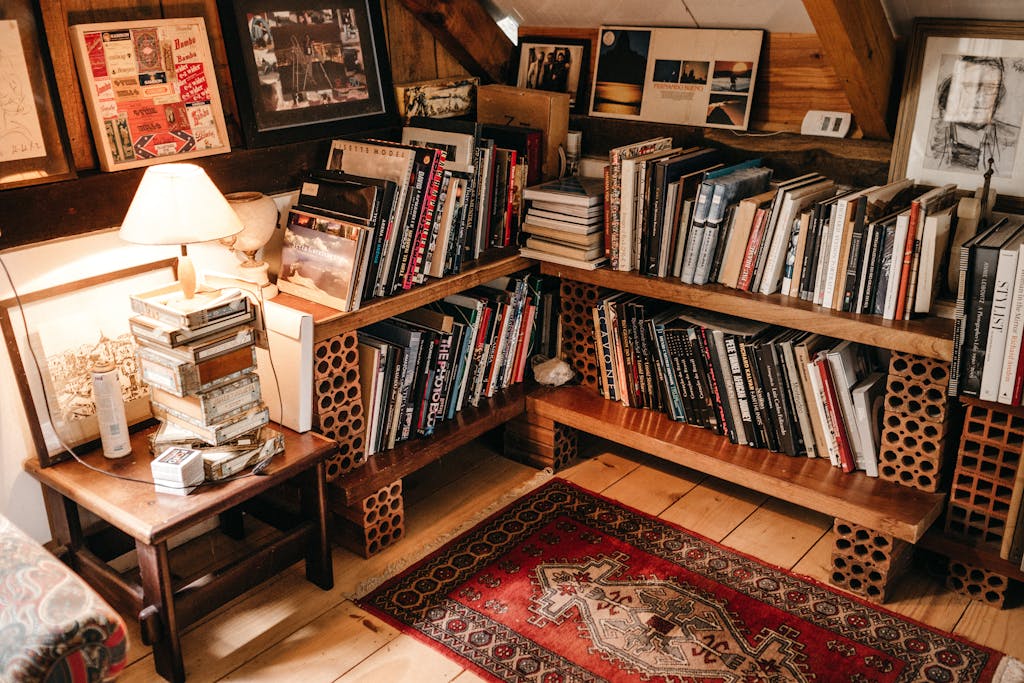Warm and inviting home library with wooden shelves filled with books and soft lighting.