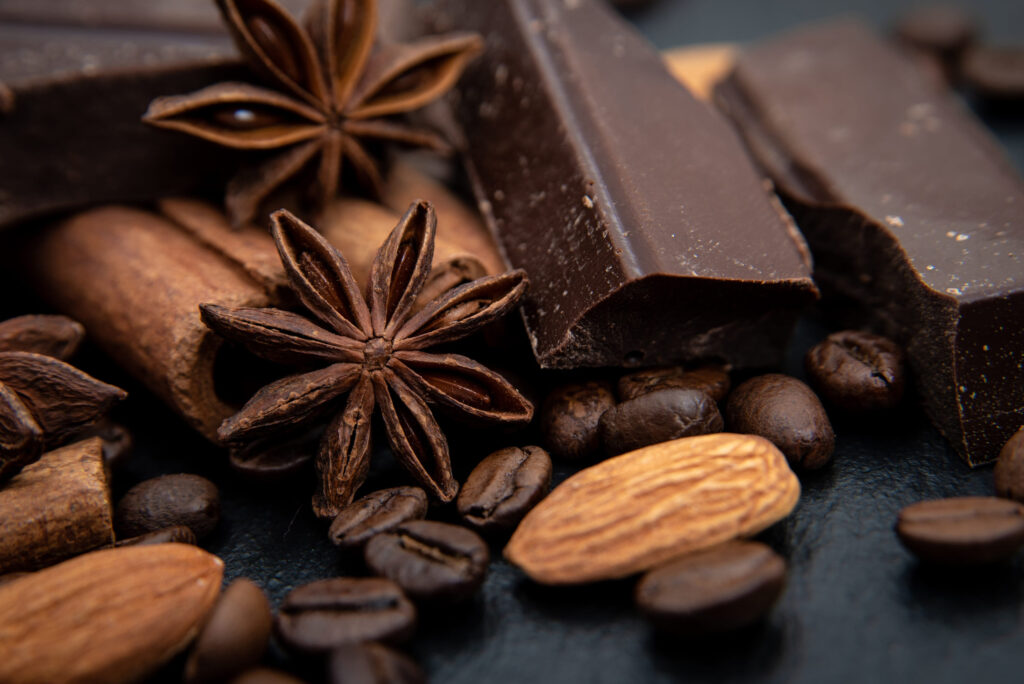 Spicy background. Cinnamon quills, chocolate, coffee beans and star anise