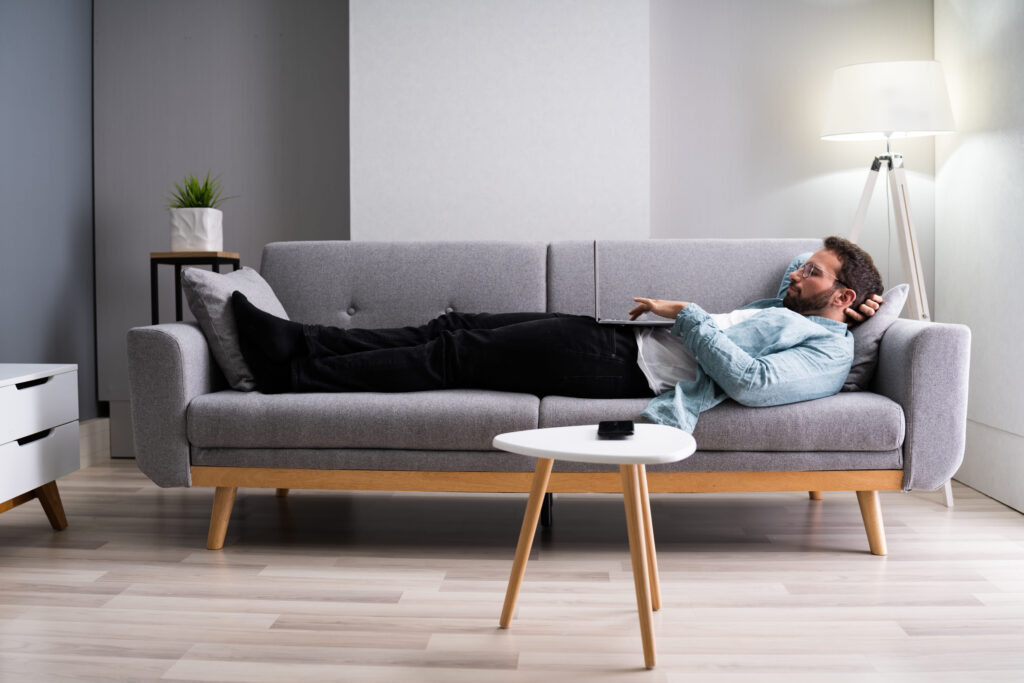 Man Watching TV Video On Sofa Or Couch