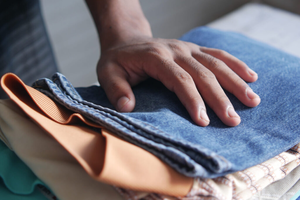 close up of stack of clothes on table .