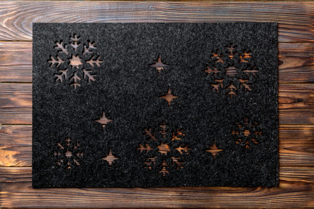 Top view of gray tablecloth for food on wooden background. Empty space for your design.