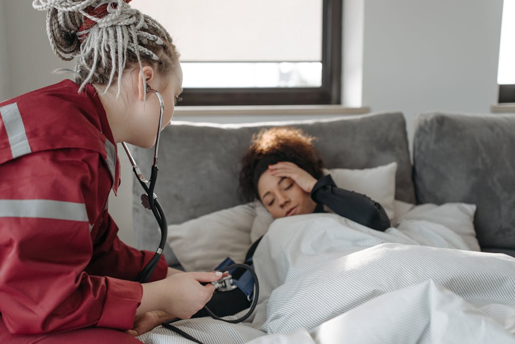 8 Things on Google That Could Ruin Your Peace of Mind 1 A paramedic examines a sick woman with a stethoscope indoors, providing medical care.
