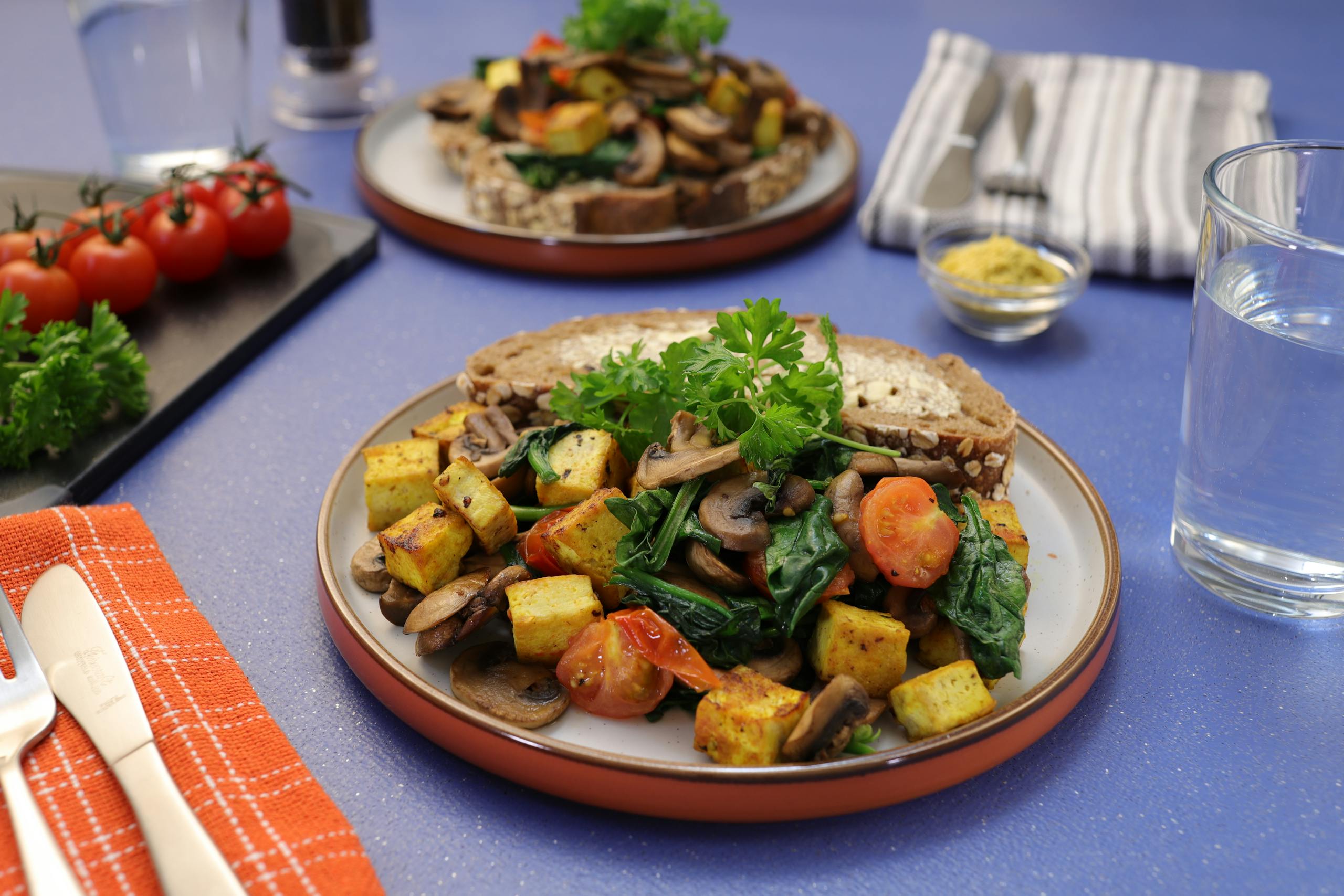 A vibrant vegan breakfast with tofu, mushrooms, and tomatoes. Perfect for a healthy start.