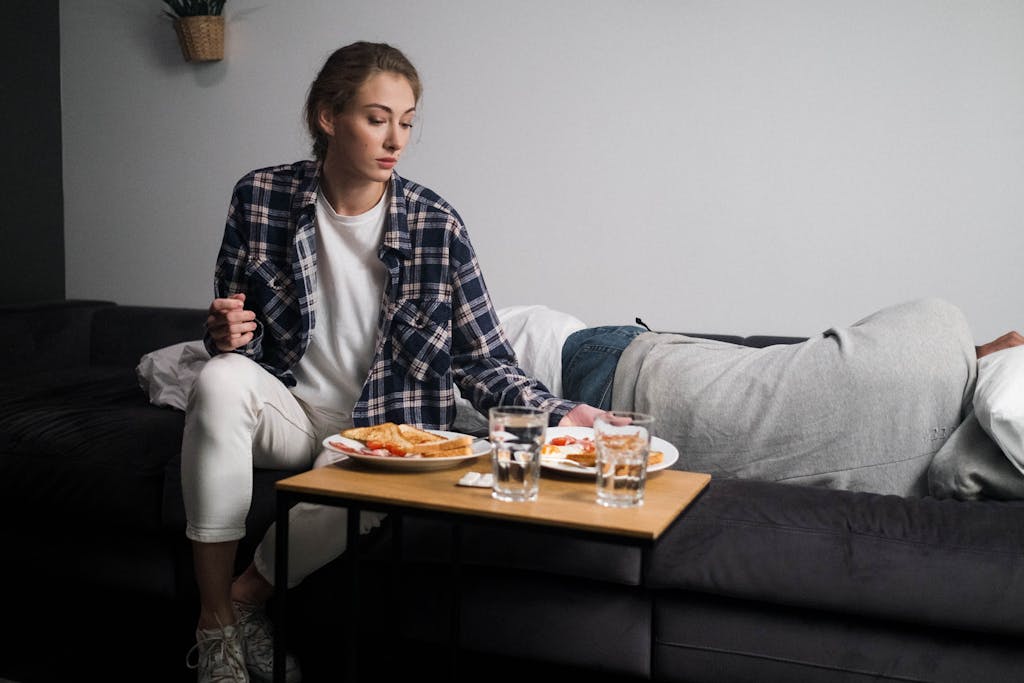 A woman takes care of a partner facing emotional struggles, highlighting compassion.