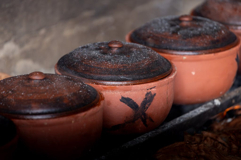 Authentic Vietnamese clay pots used for cooking over open fire, showcasing traditional culinary methods.