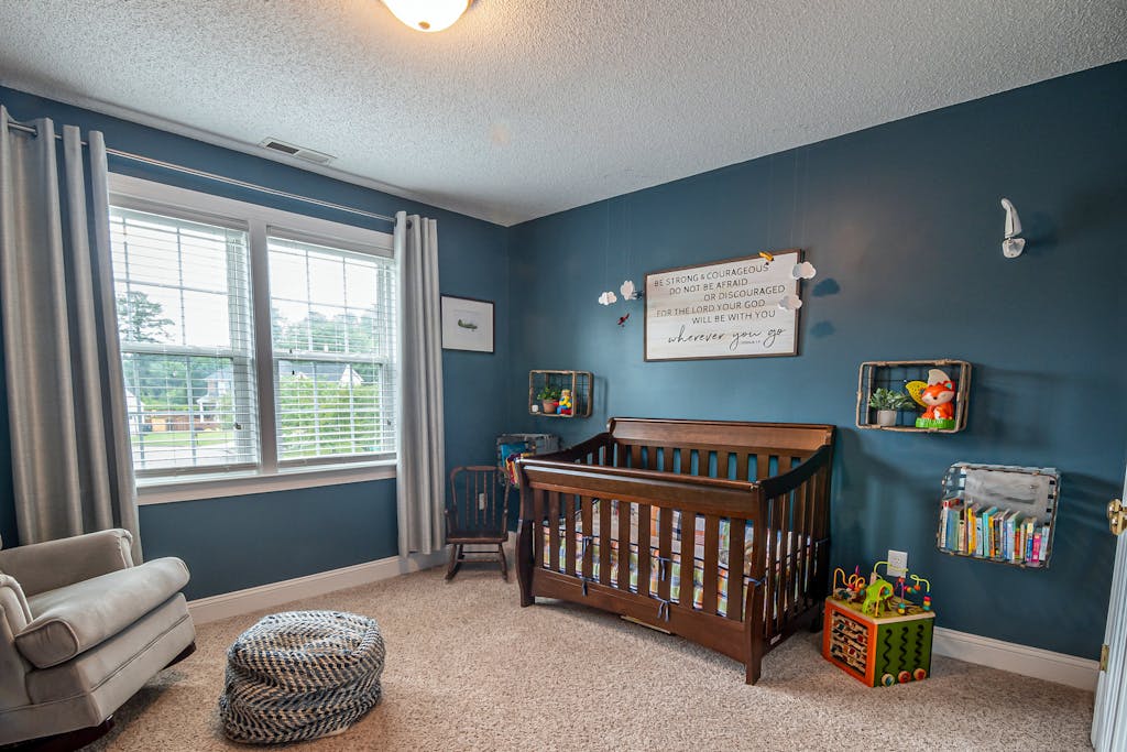 Charming and comfortable baby room interior with crib and toys enhancing a warm home setting.