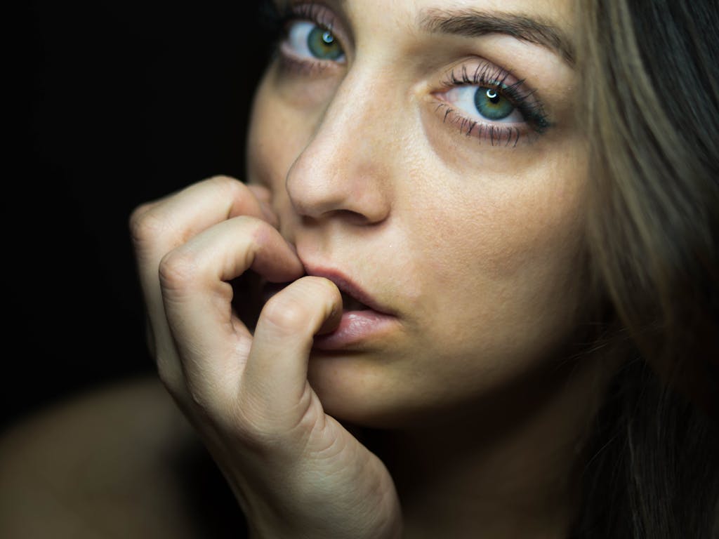 Close-up portrait capturing a woman's intense and thoughtful gaze with green eyes.