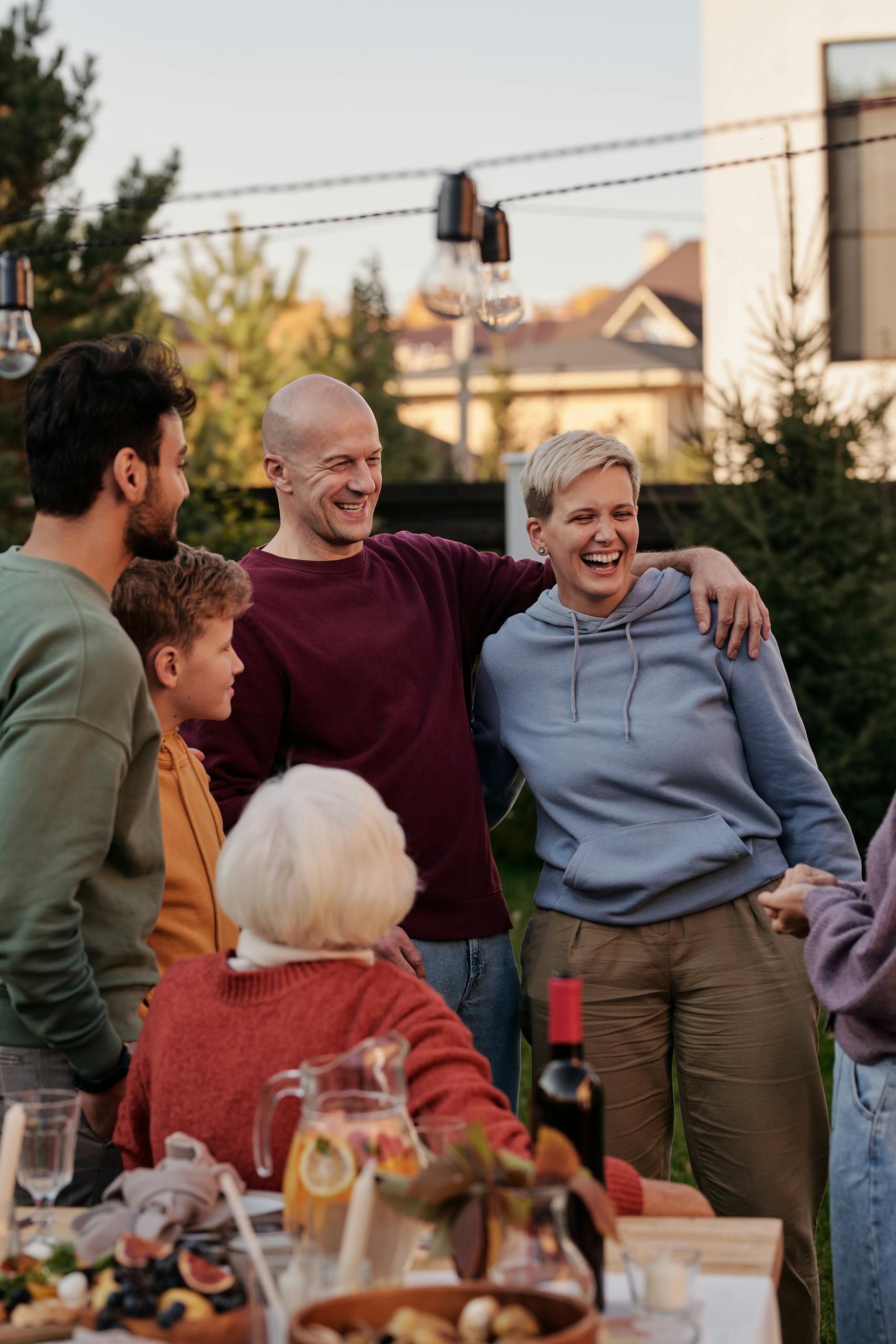 Happy family enjoying a warm outdoor meal together, celebrating love and togetherness.