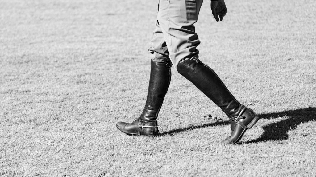 close-up-of-equestrian-boots-on-grass-field-