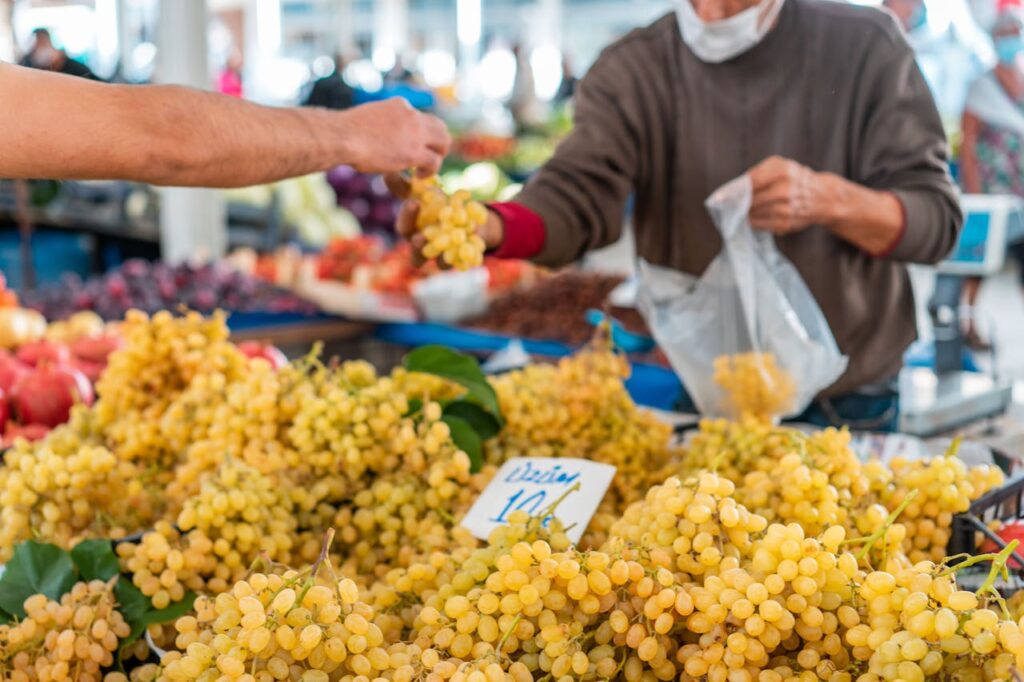 man-buying-grapes-on-a-street-market-