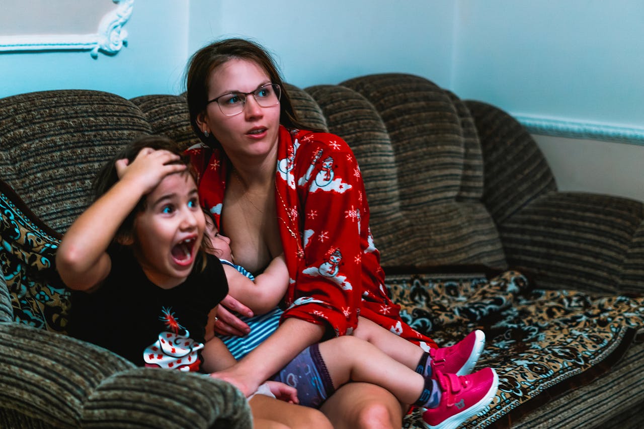 a-woman-sitting-on-a-sofa-with-her-children