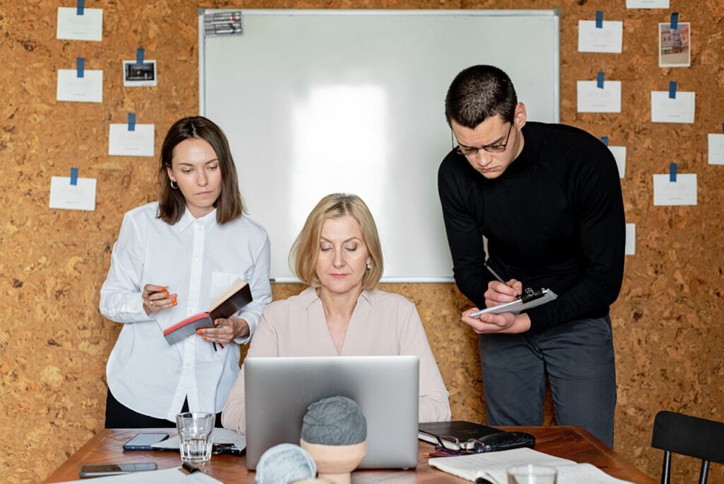 /people-in-the-office-having-meeting-while-taking-notes