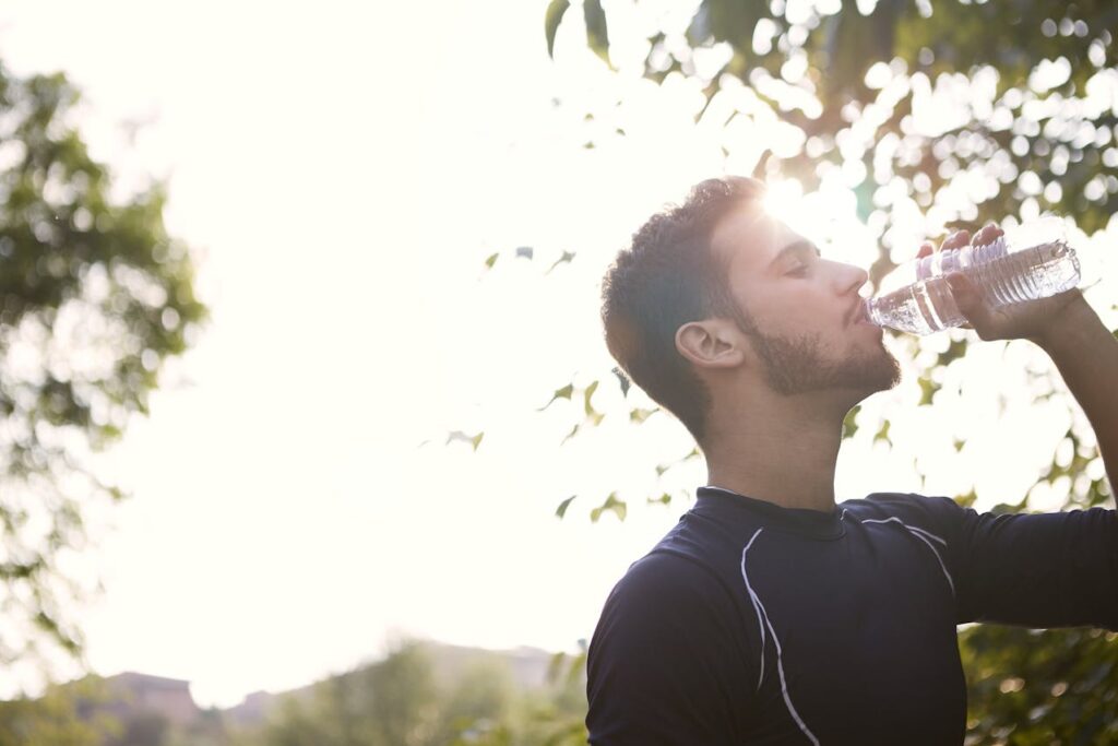 /man-in-black-crew-neck-shirt-drinking-water-