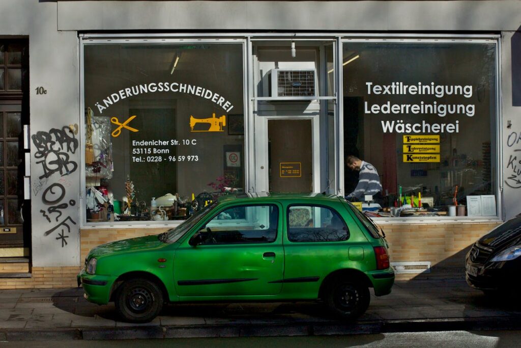 /small-tailor-shop-with-green-car-outside-in-bonn-