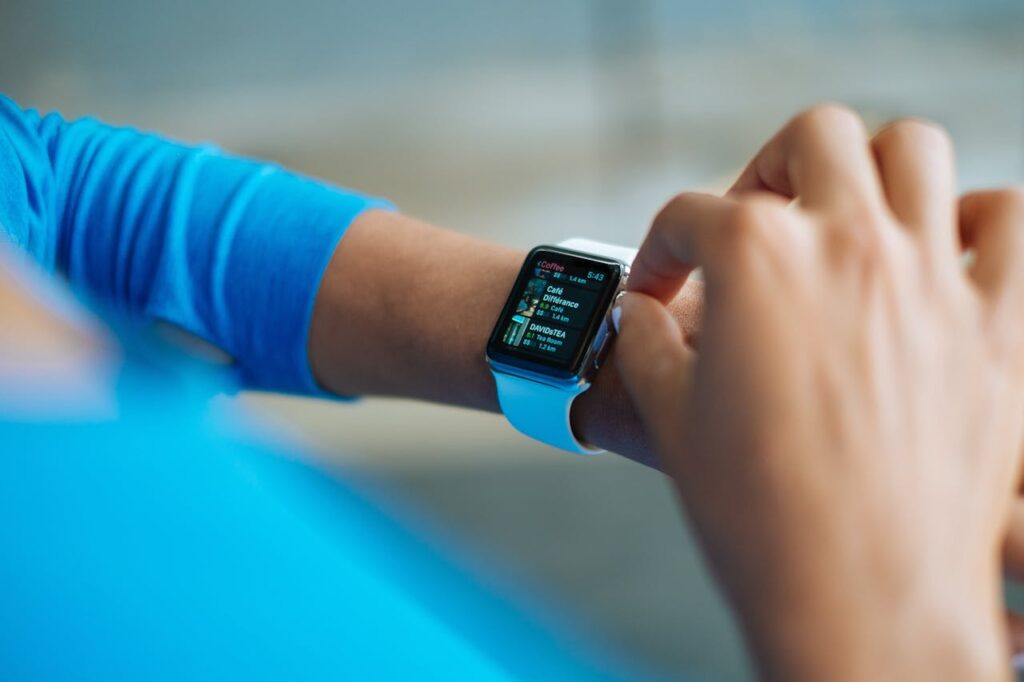 person-in-blue-long-sleeve-shirt-using-smart-watch