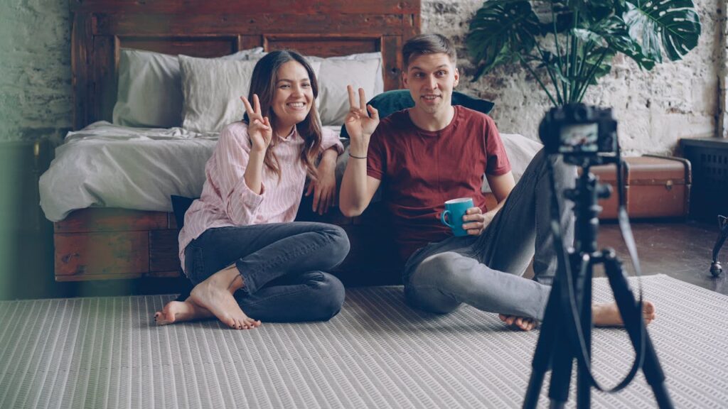 smiling-couple-recording-vlog-at-home-interior-