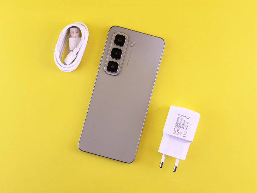 /stylish-smartphone-with-charger-on-yellow-background-