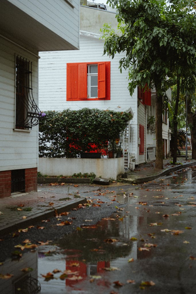 Quaint old house with red shutters on a rainy autumn day in Istanbul, Türkiye.