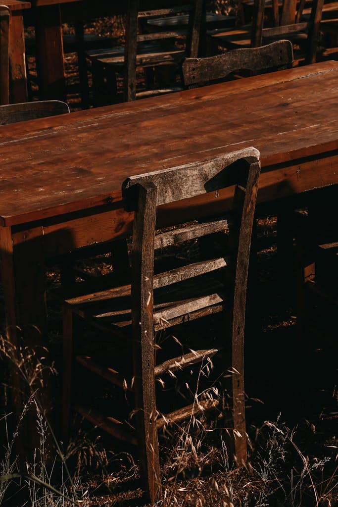 Wooden table and chairs with rustic charm, captured in a rural outdoor setting.