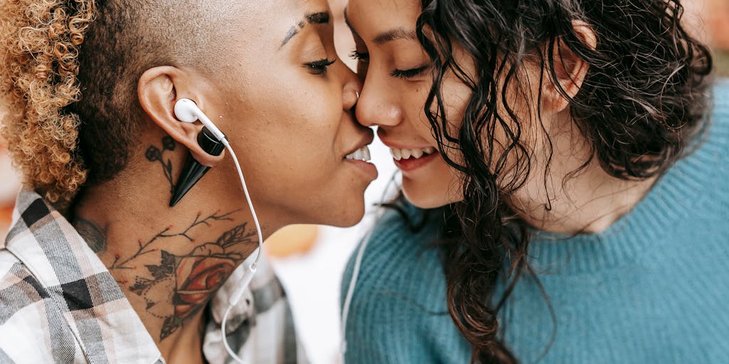 A close-up portrait capturing a tender moment between two women in love.