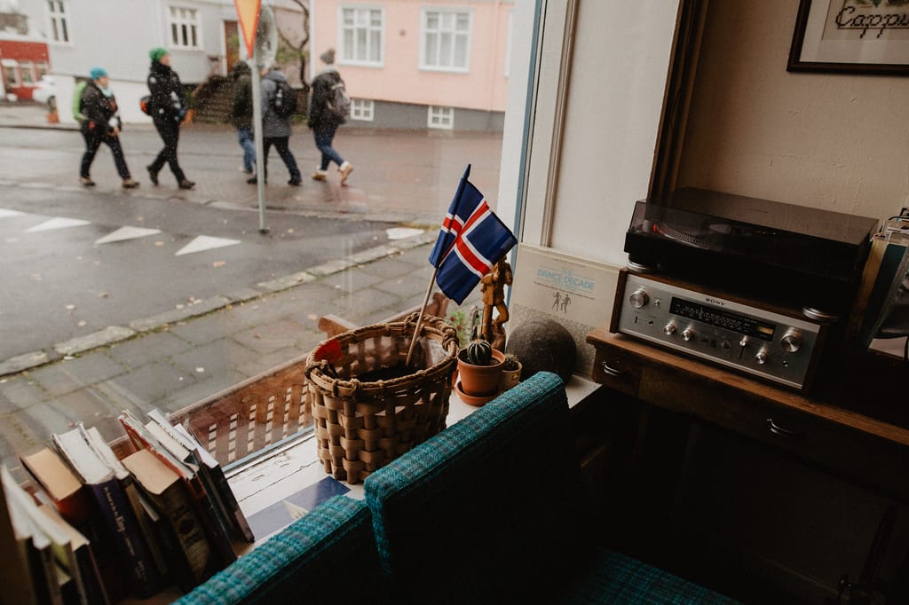 A cozy corner in a Reykjavik café featuring Icelandic decor and a view of the city street.