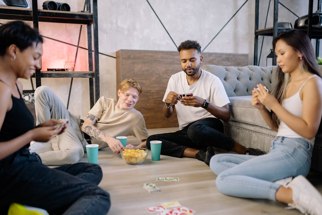 A diverse group of friends enjoying a card game indoors, creating a relaxed and fun atmosphere.