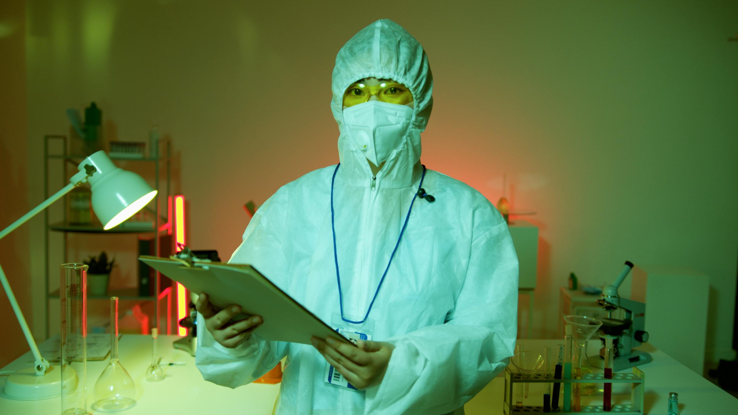 A scientist in full protective gear conducting research in a laboratory setting.