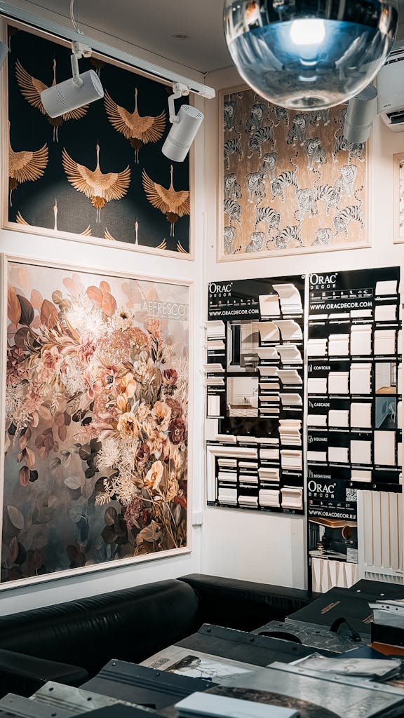 Artistic wall panels and decor in an interior design store, featuring floral and animal prints.