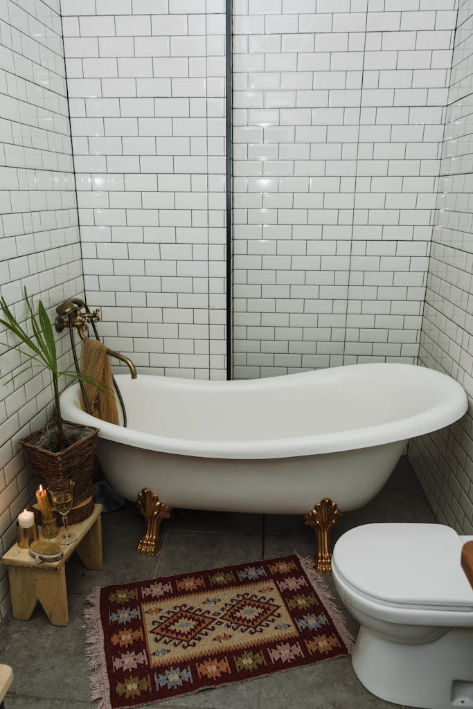Charming bathroom featuring a classic clawfoot tub, candles, and rustic decor for a cozy ambiance.