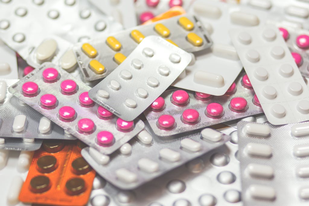 Close-up of various colored pills in blister packs, showcasing medicine assortment.