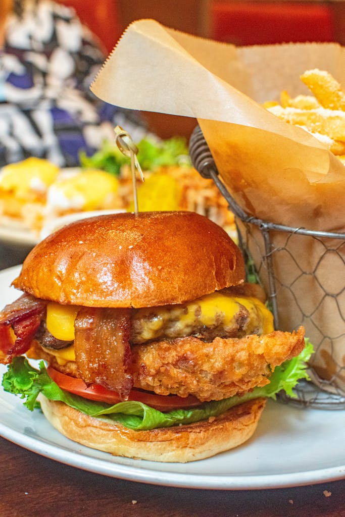 Delicious cheeseburger with crispy bacon and fries served in a New York restaurant.