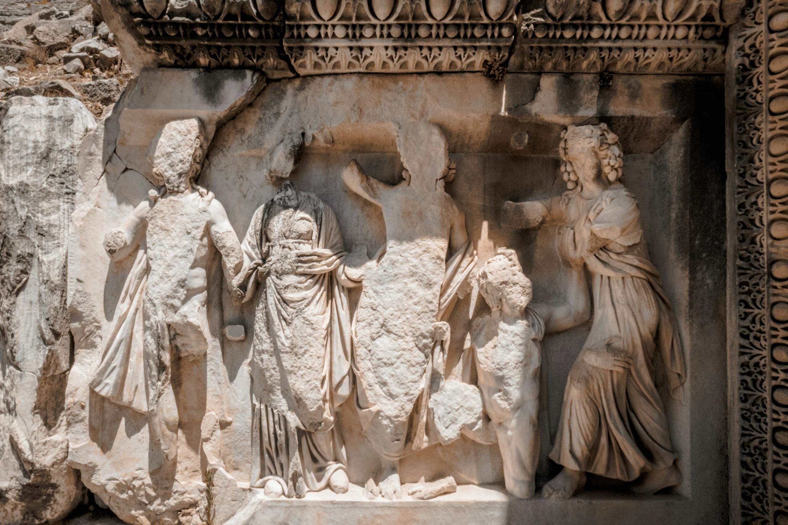 Detailed marble relief from the ancient Perge ruins in Turkey, showcasing classical architectural artistry.
