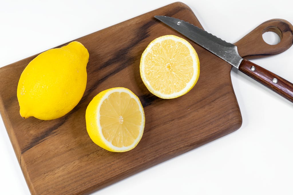Fresh lemons on a wooden cutting board, perfect for recipes and refreshing drinks.