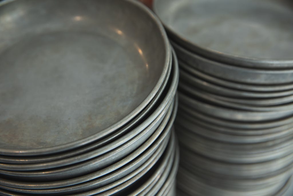 From above of assorted round baking sheets placed on counter in shop in daytime