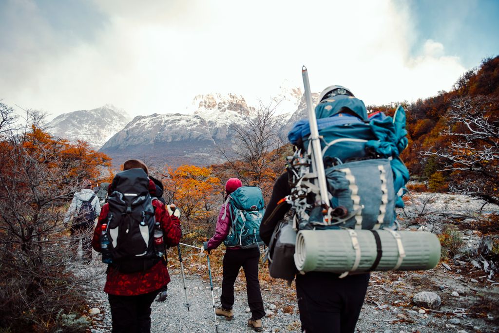 Group of backpackers trekking through the autumn colors in El Chalten, Argentina.