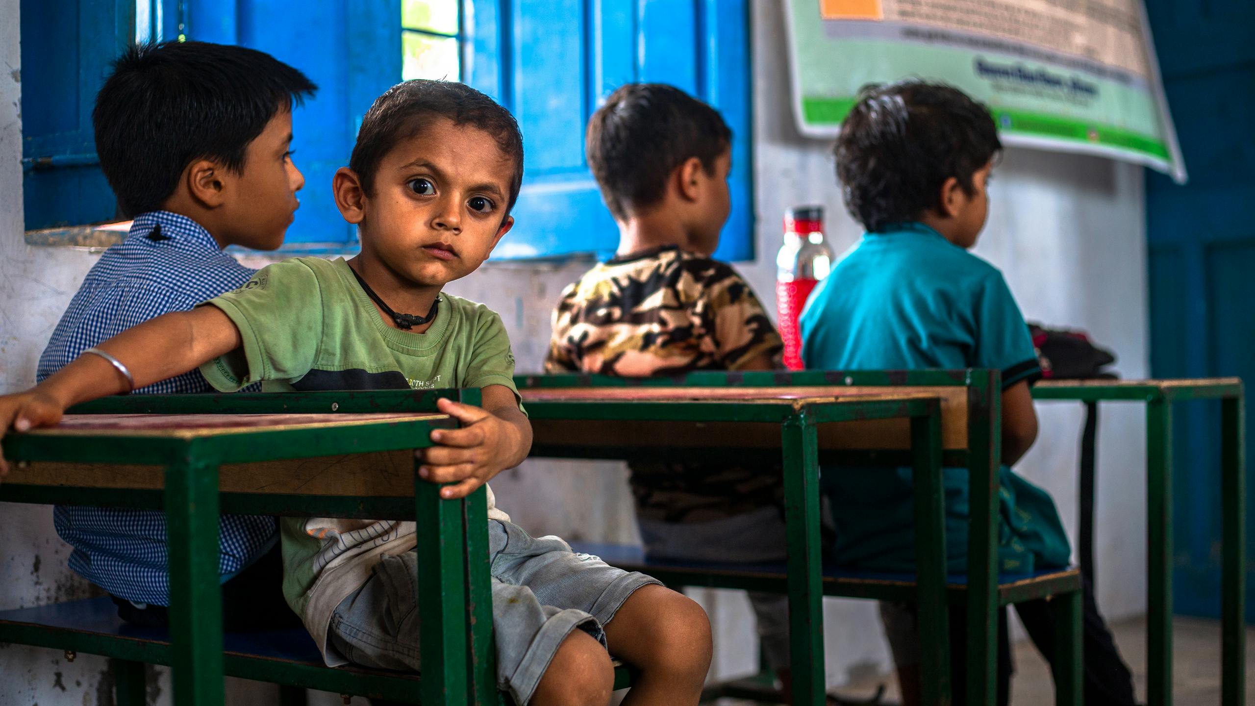 Group of children in an Indian classroom engaging in learning and interaction.