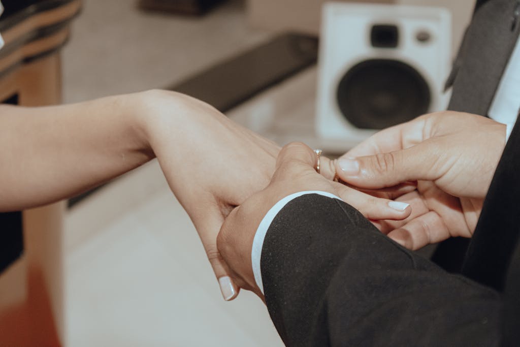 Intimate moment of a couple exchanging rings, symbolizing commitment and love.