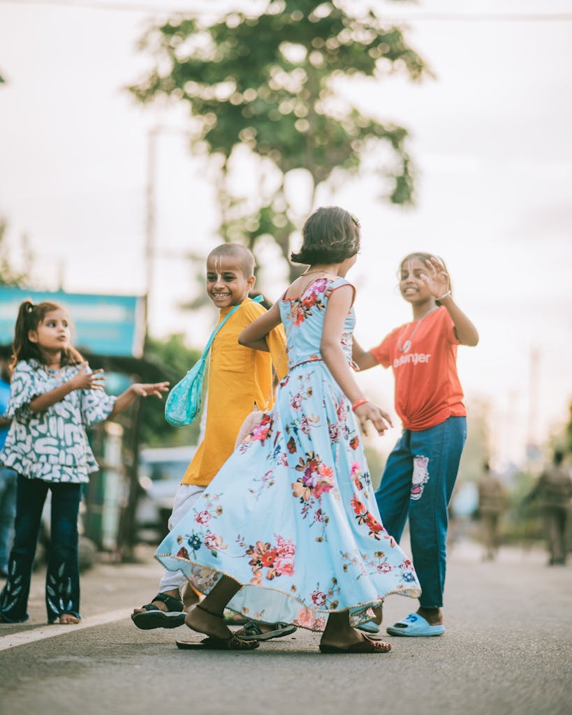 Lively group of children playing happily outdoors on a street in India during summer.