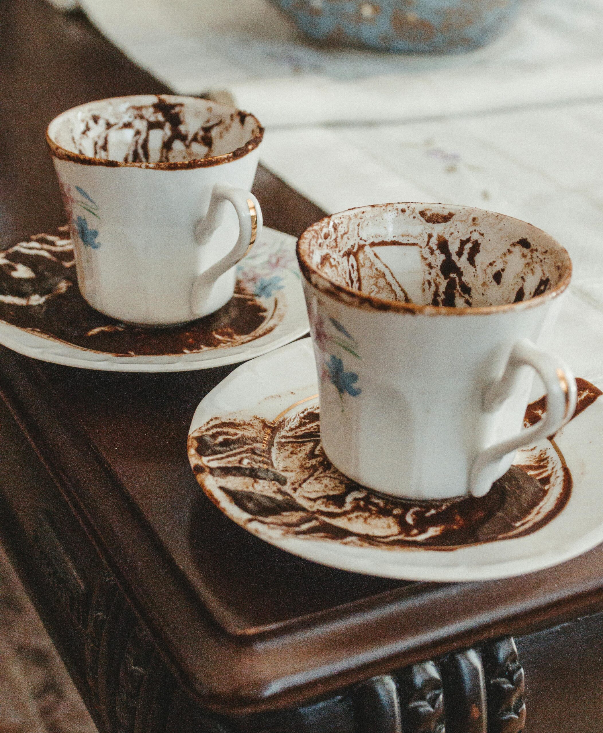 turkish-coffee-cups-with-residue-on-wooden-table