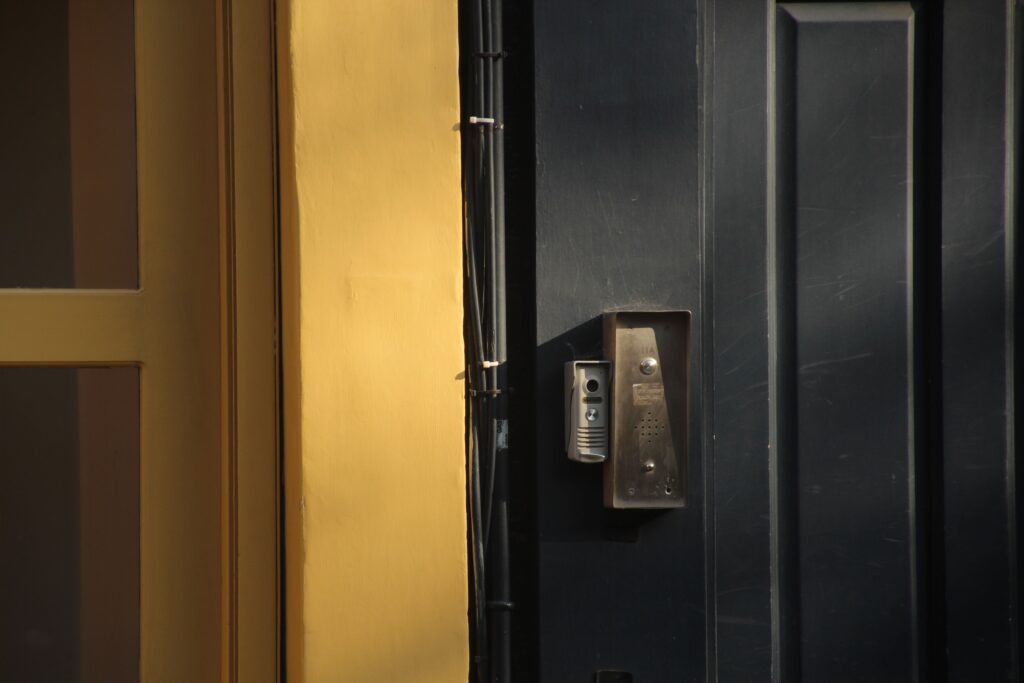 dark-door-with-yellow-frame-and-intercom-system